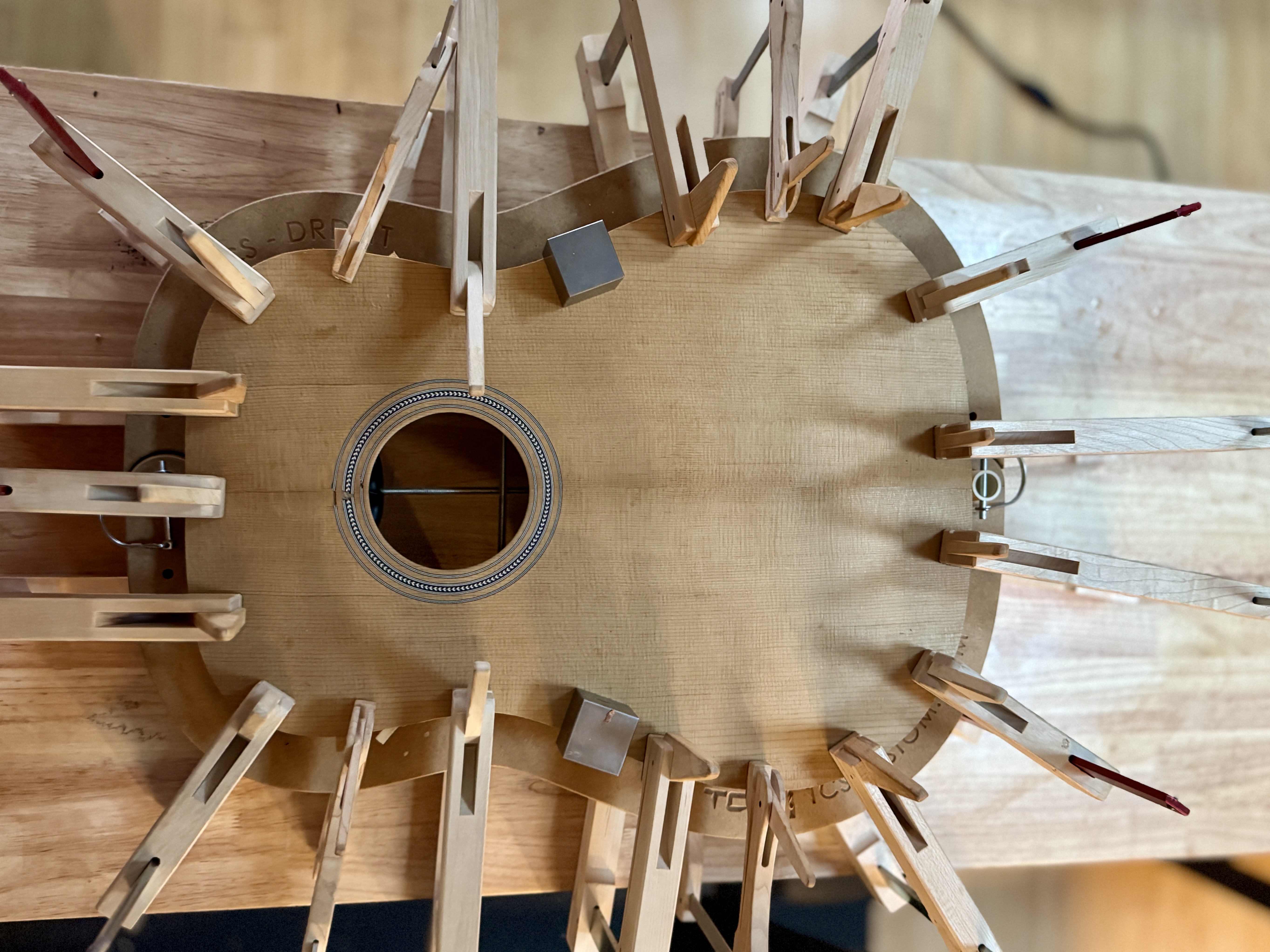 Guitar top being clamped during glue-up at the Six Sides bench