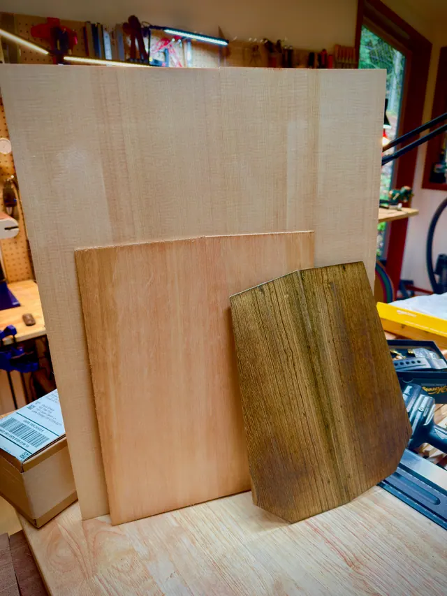 Top and back sets leaning against the bench in the light from the shop window