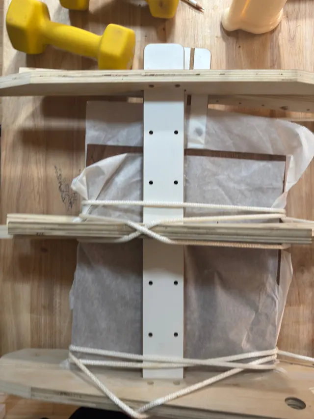 Rope wound around the clamping jig, holding a glue joint closed