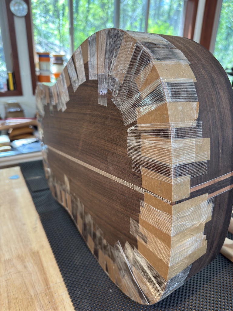 Walnut body with kerfing taped while glue sets